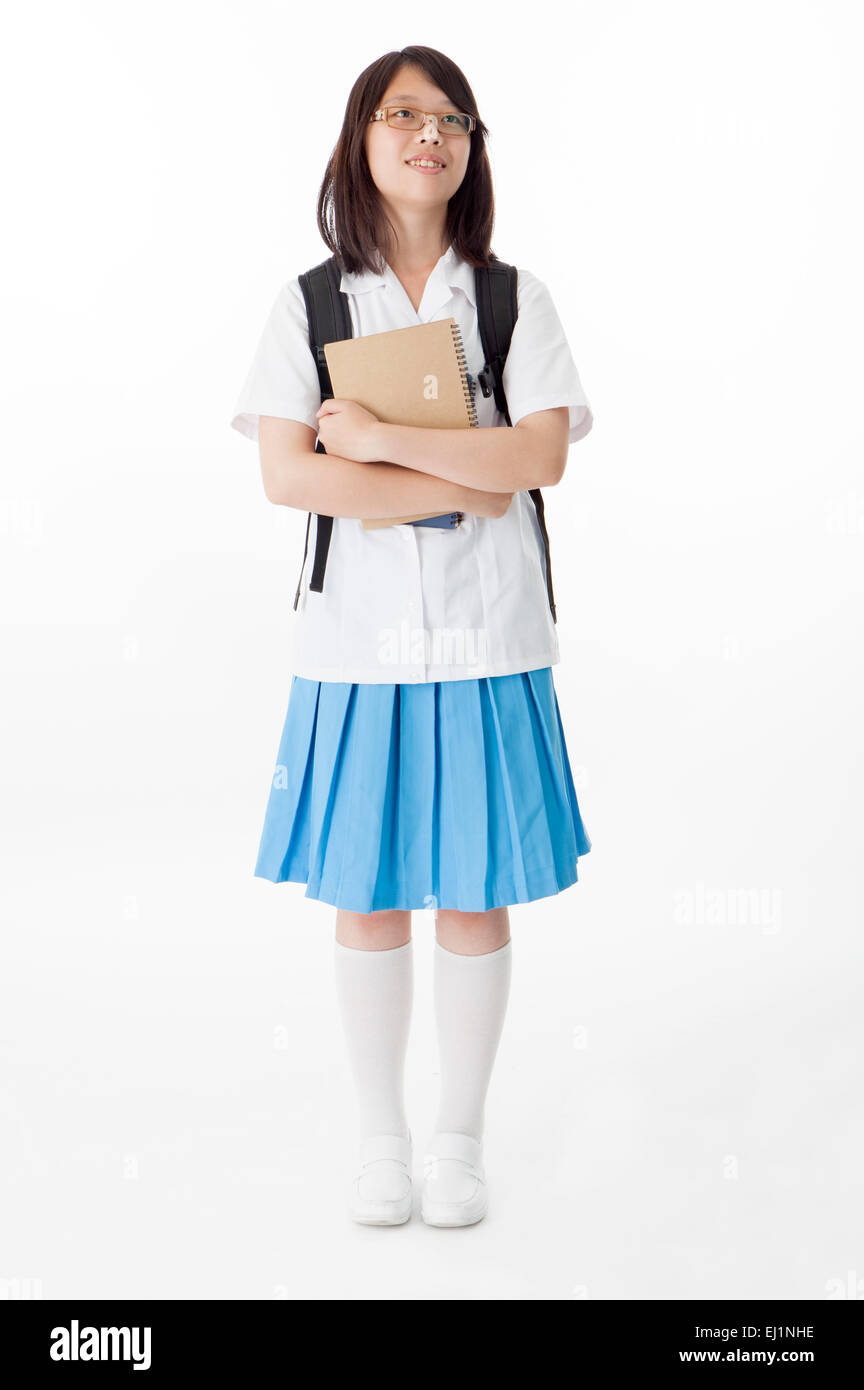 Teenage girl standing and holding books with smile Stock Photo - Alamy