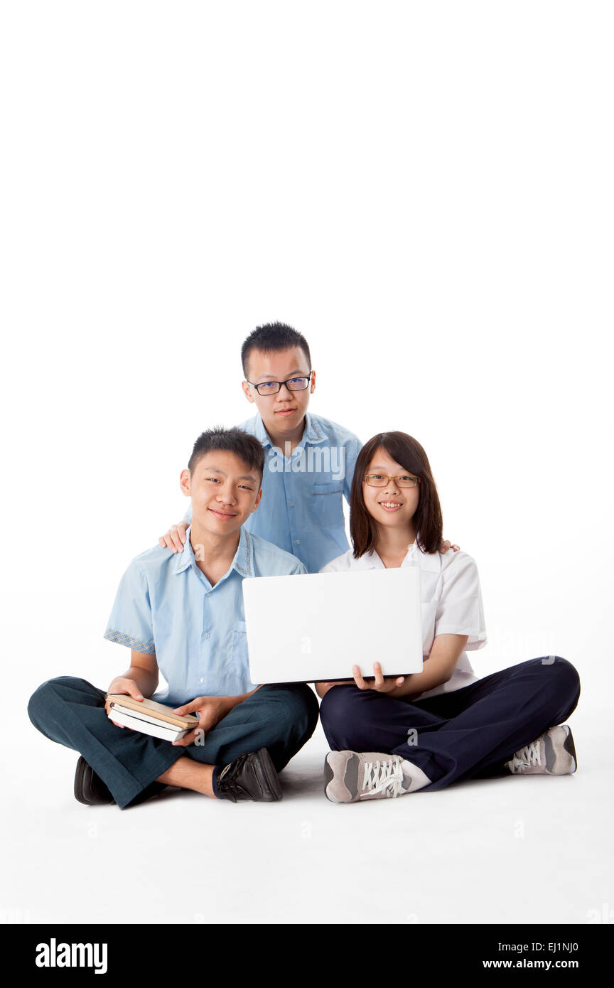 Teenagers sitting and smiling at the camera Stock Photo