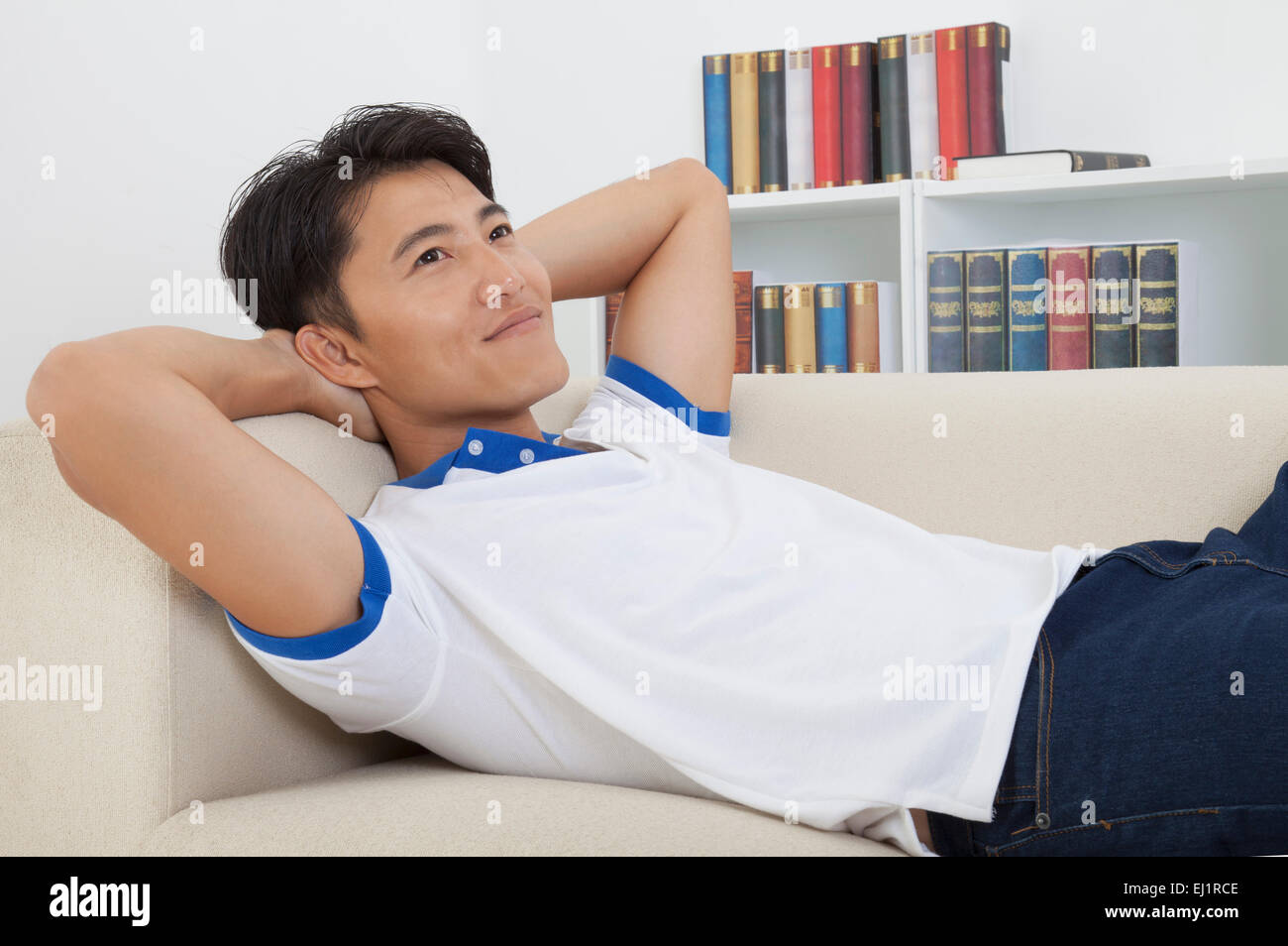 Man lying on back and relaxing with smile Stock Photo