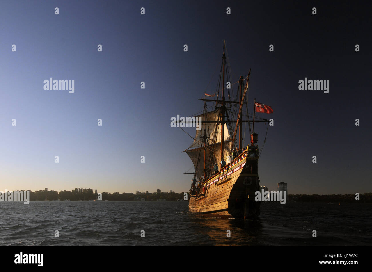 Replica ship the Duyfken sailing at twilight on the Swan River, with Perth city skyline in background, Western Australia. No PR Stock Photo