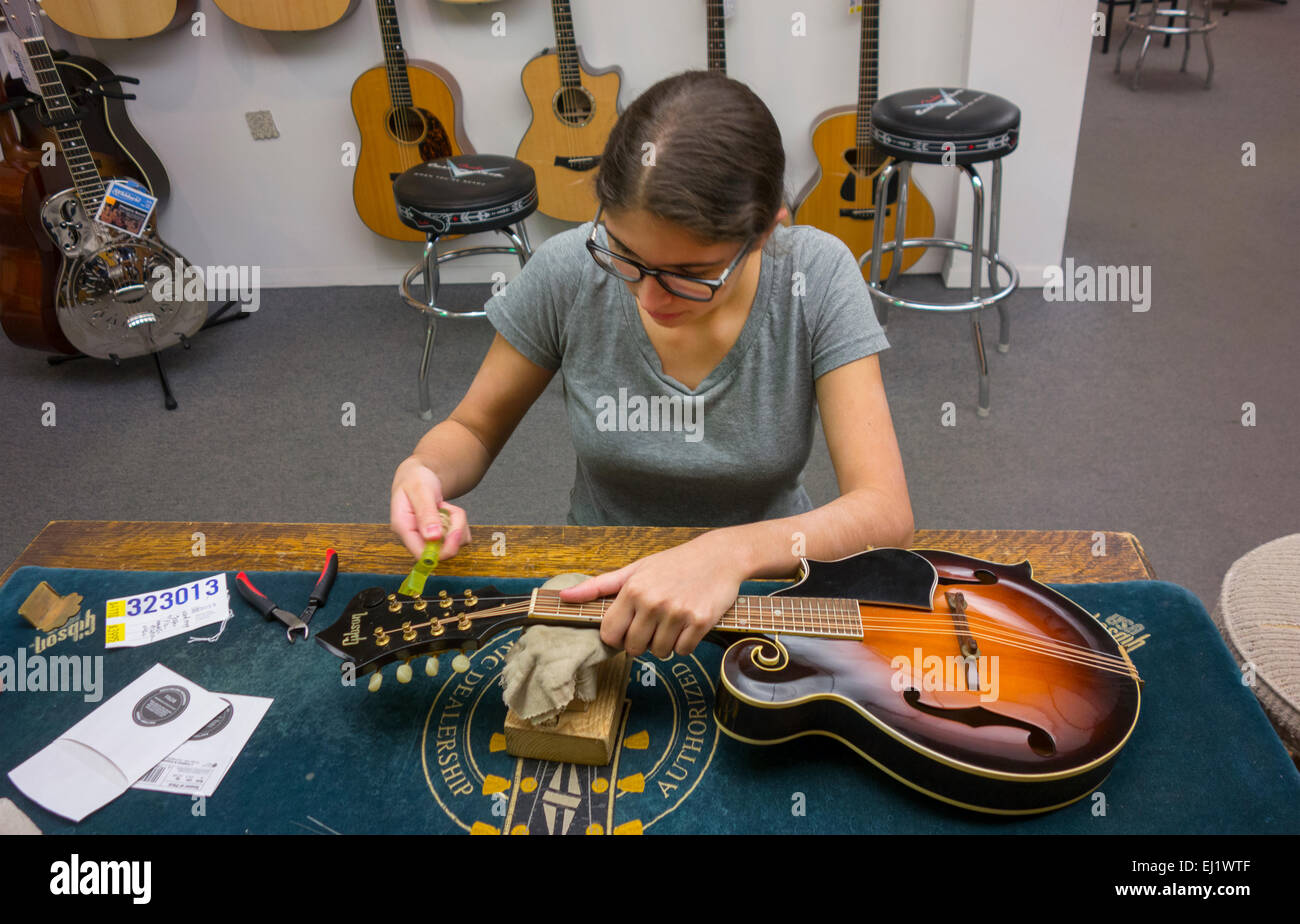 mandolin repair woman at Mandolin Brothers in Staten Island NYC Stock