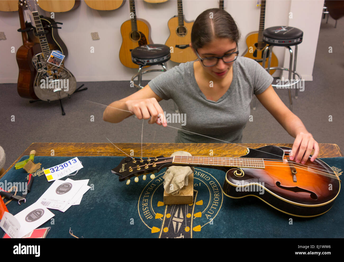 mandolin repair woman at Mandolin Brothers in Staten Island NYC Stock