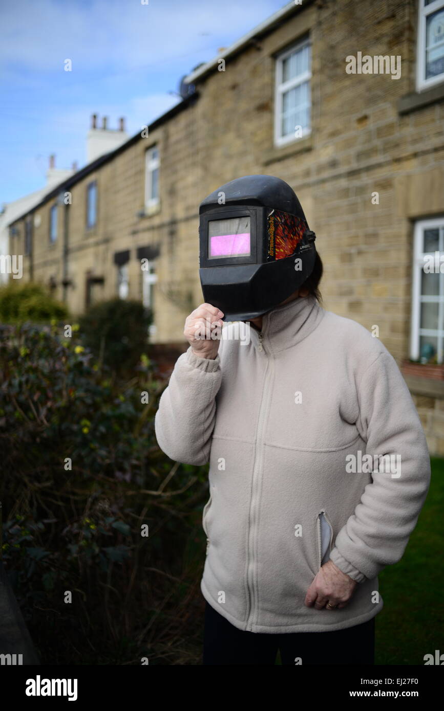 Barnsley, UK. 20th March 2015. 72 Year old Glenys Goodwin with a welders mask she used to view the 2015 partial solar eclipse. Stock Photo