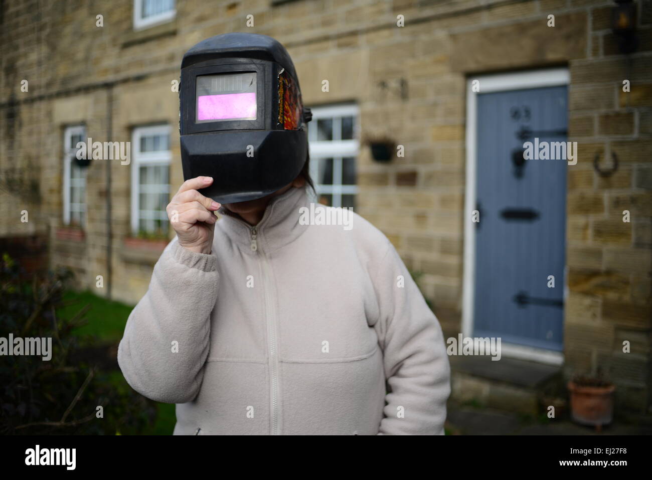 Barnsley, UK. 20th March 2015. 72 Year old Glenys Goodwin with a welders mask she used to view the 2015 partial solar eclipse. Stock Photo
