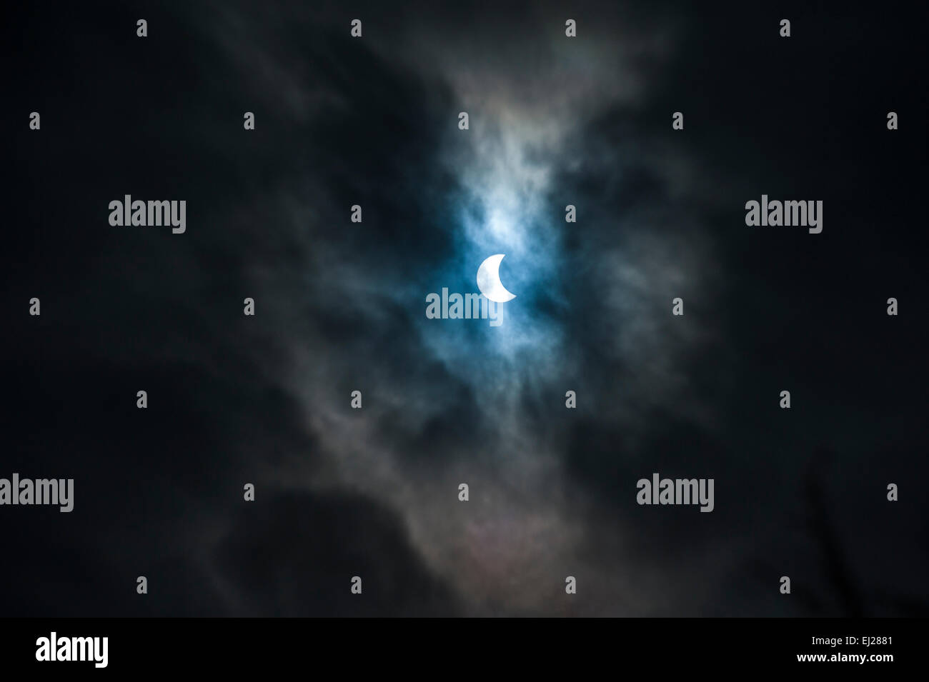 Solar Eclipse Through Mysterious Clouds. Stock Photo