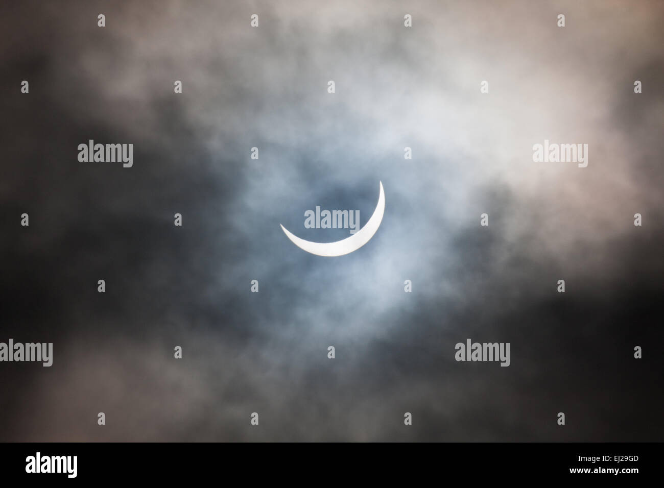 The moon has started to move off and the sun is reemerging Stock Photo