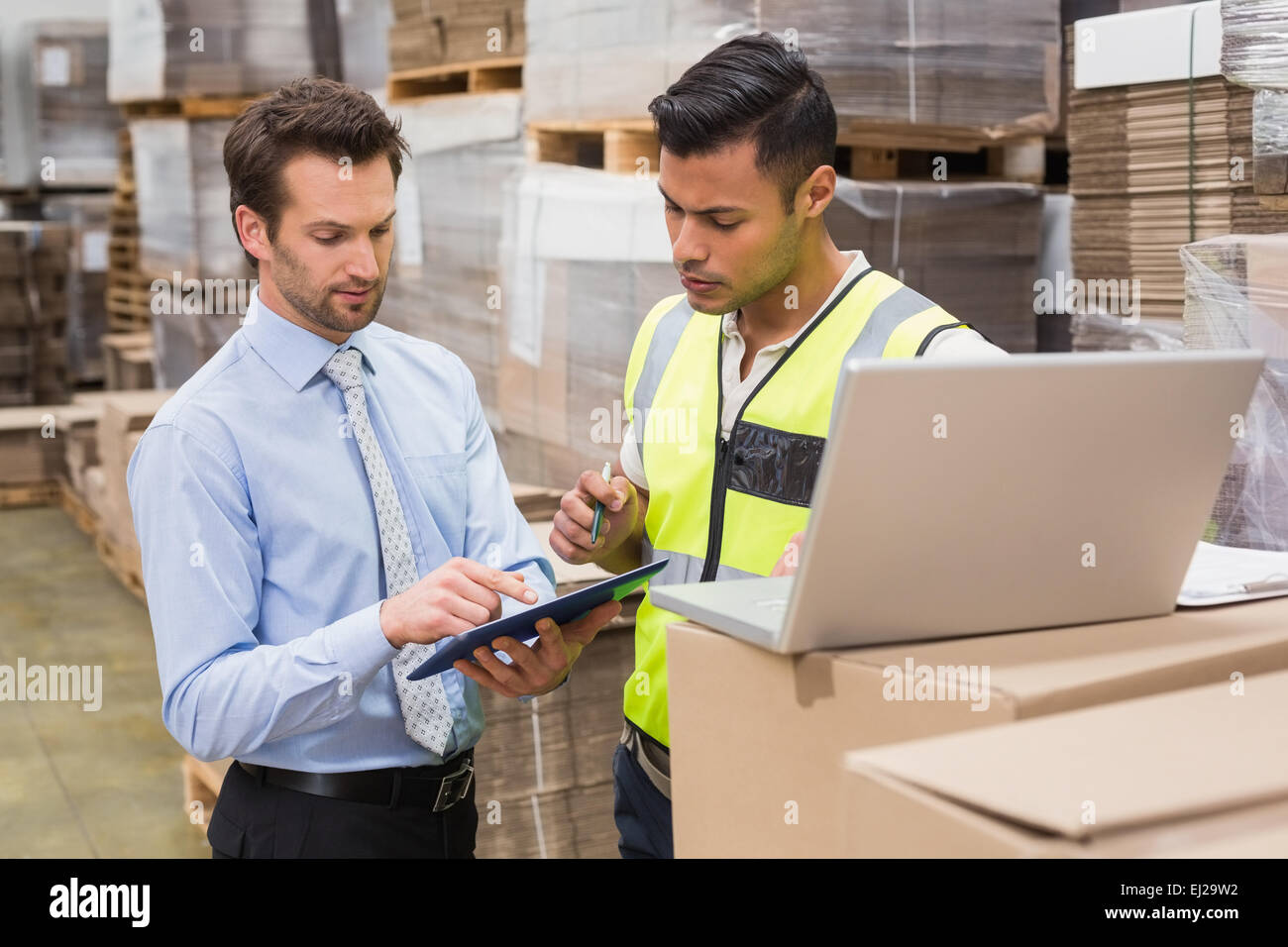 Warehouse worker and manager working together Stock Photo - Alamy
