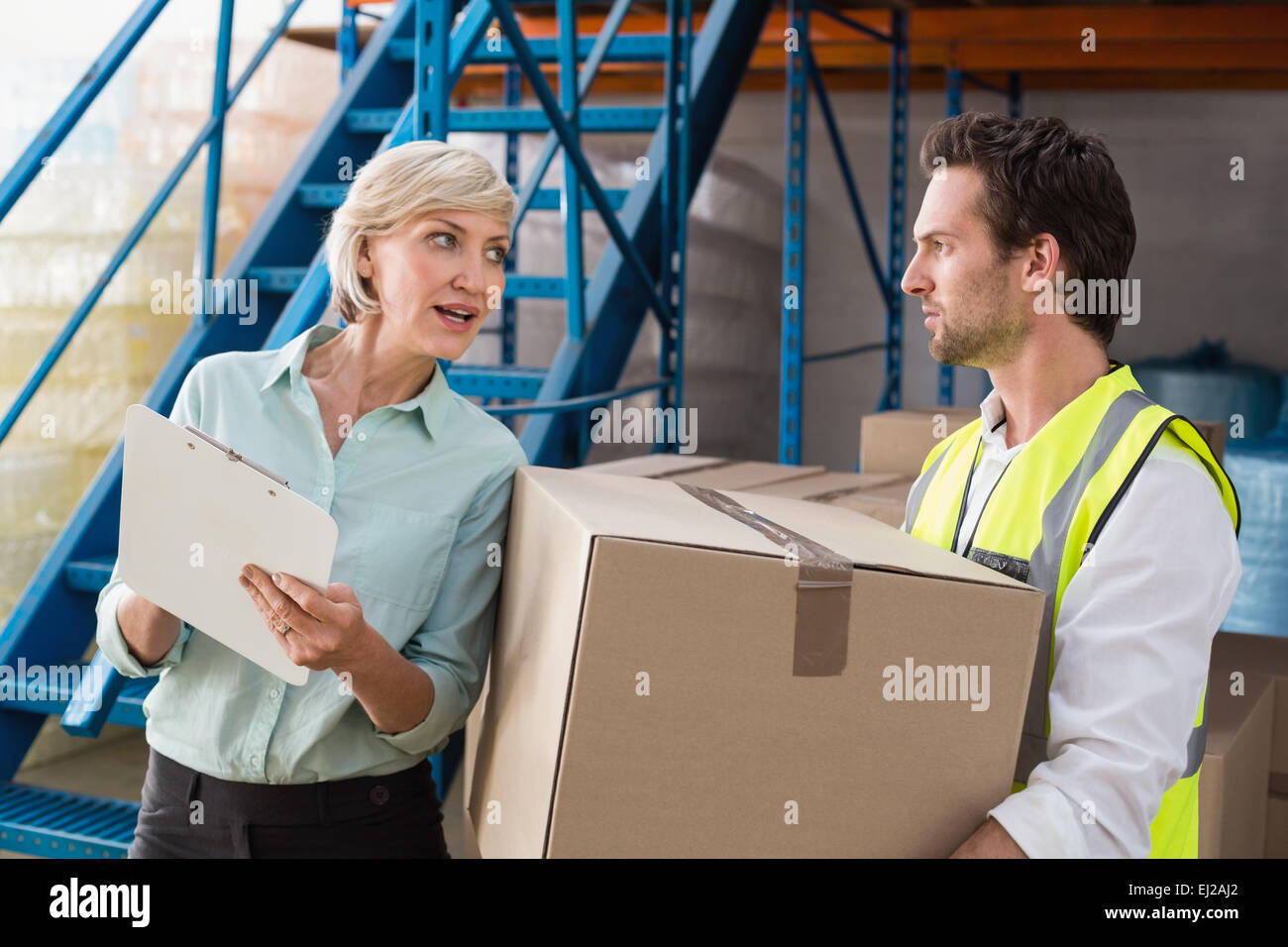 Warehouse manager and worker talking together Stock Photo - Alamy
