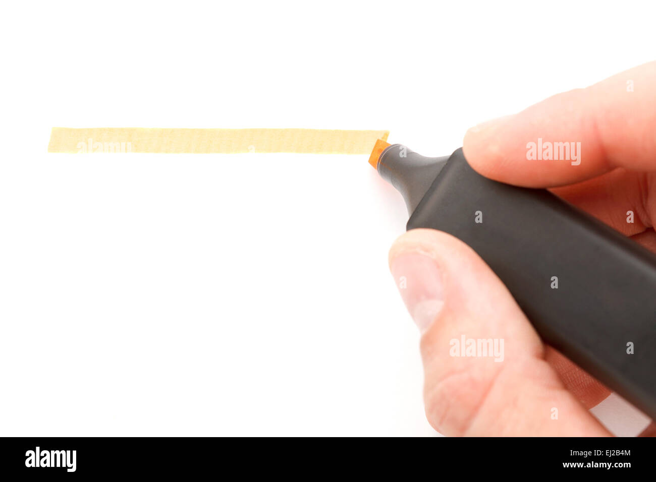 Orange highlighter in hand on w white background Stock Photo - Alamy