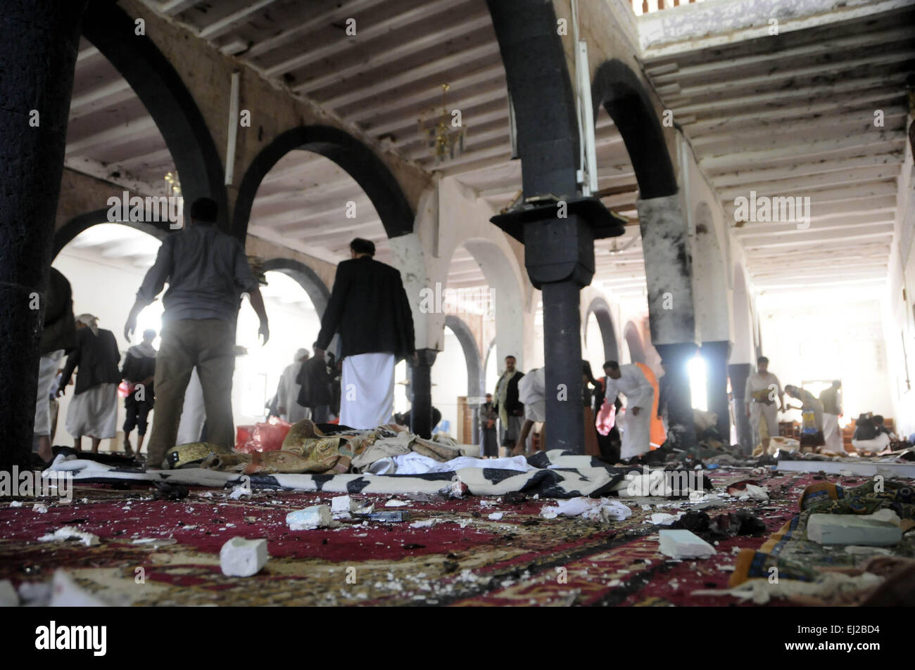 Sanaa, Yemen. 20th Mar, 2015. People clear a mosque after a suicide bomb attack in Sanaa, Yemen, March 20, 2015. A total of 88 people were killed and at least 100 others wounded on Friday in four bomb attacks in Yemen, local sources told Xinhua. Credit:  Hani Ali/Xinhua/Alamy Live News Stock Photo