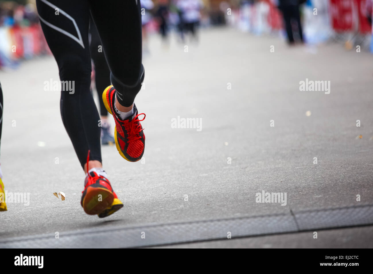 Marathon runner on finish line - legs closeup Stock Photo - Alamy