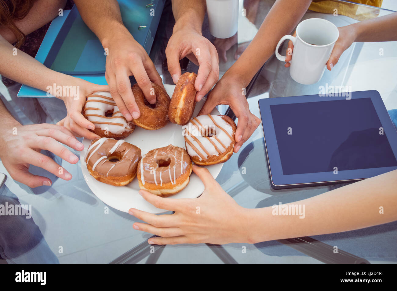 Fashion students eating doughnuts Stock Photo