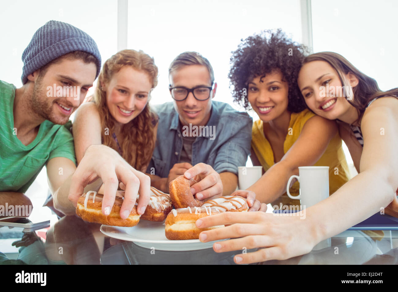Fashion students eating doughnuts Stock Photo