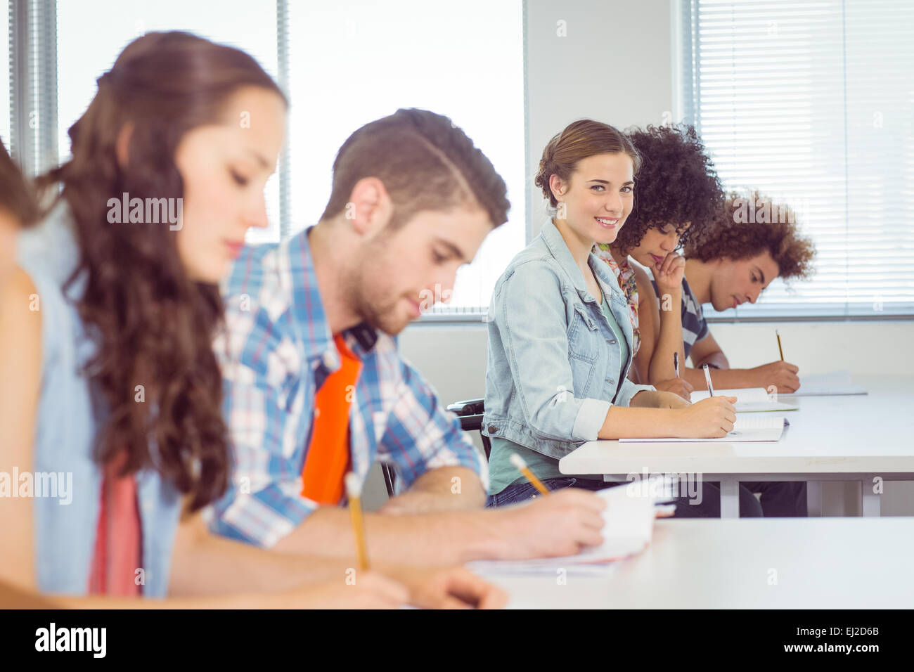 Fashion student smiling at camera in class Stock Photo - Alamy