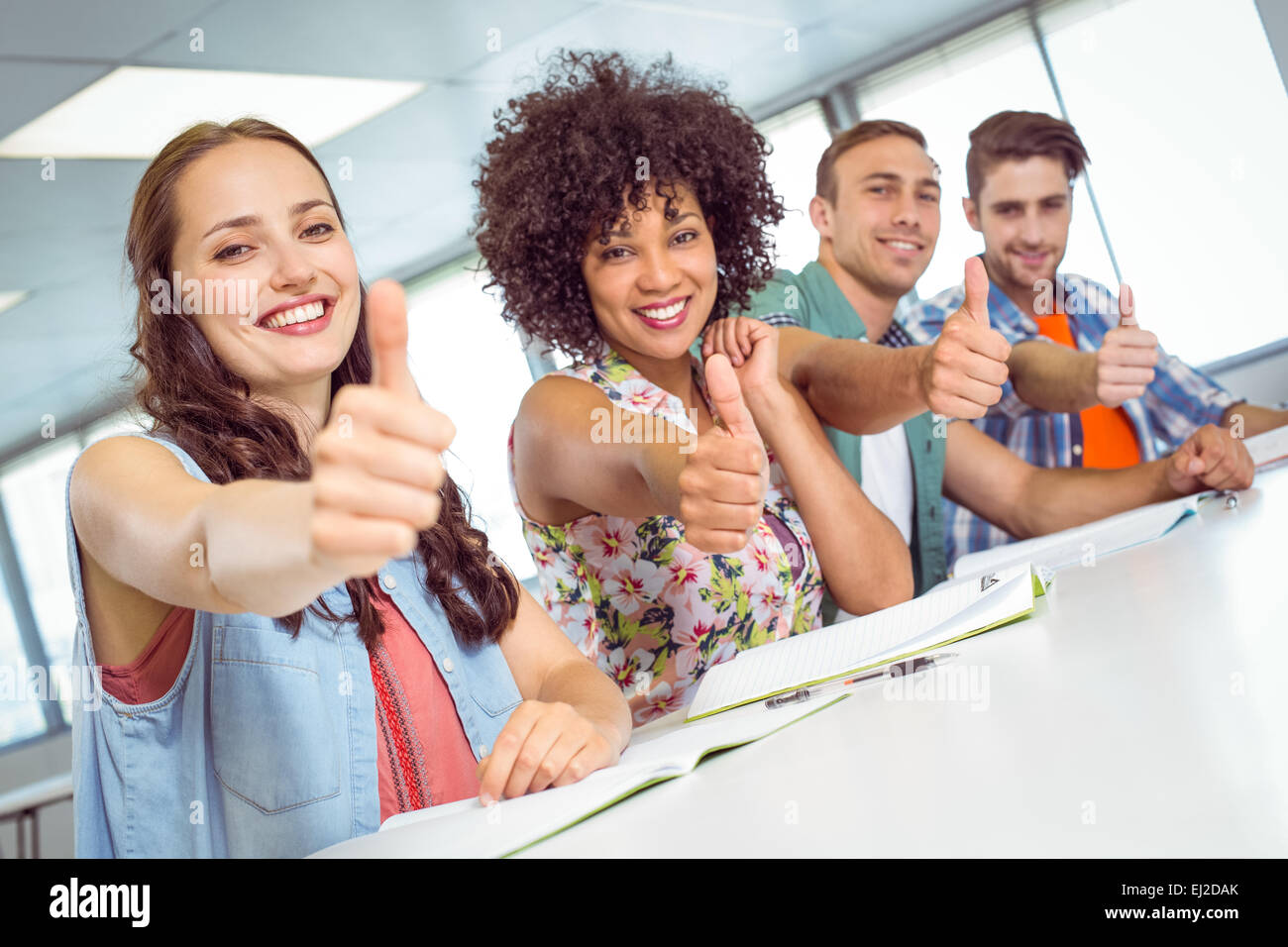 Fashion student smiling at camera with thumbs up Stock Photo - Alamy