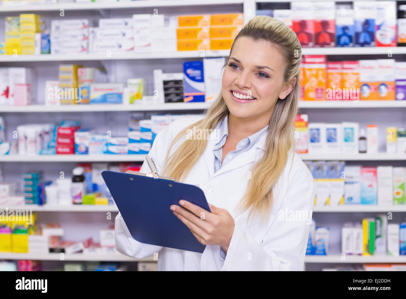 Pharmacy intern writing on clipboard Stock Photo