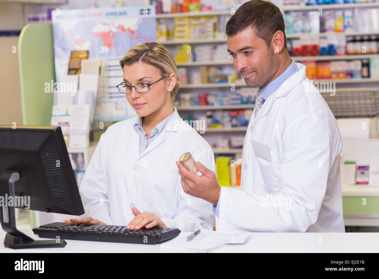 Team of pharmacists looking at the computer Stock Photo