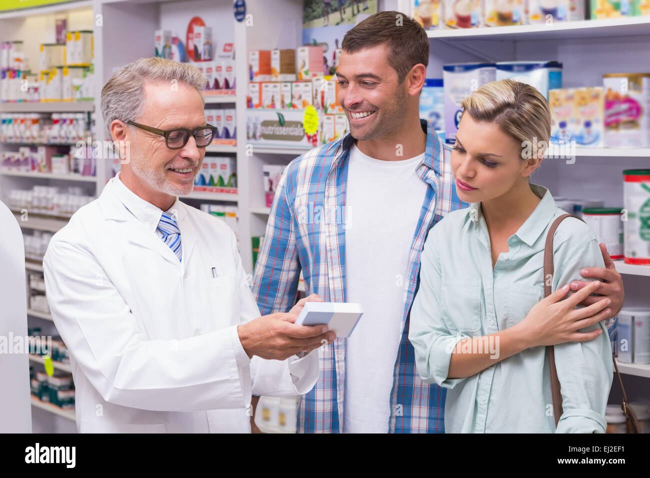 Pharmacist and costumers smiling Stock Photo