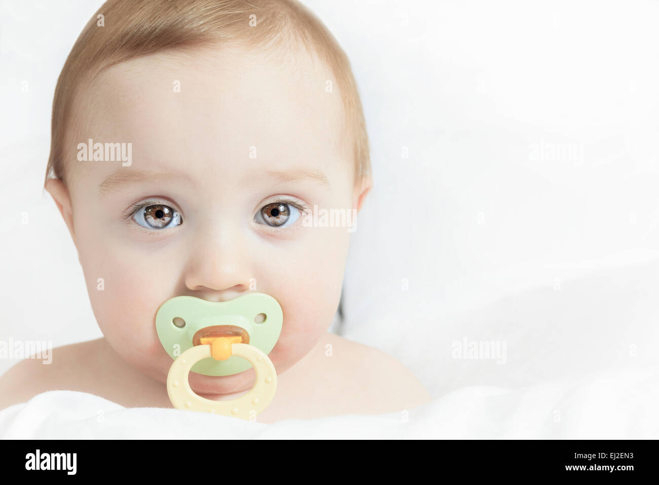 Baby portrait on the bed with white background Stock Photo