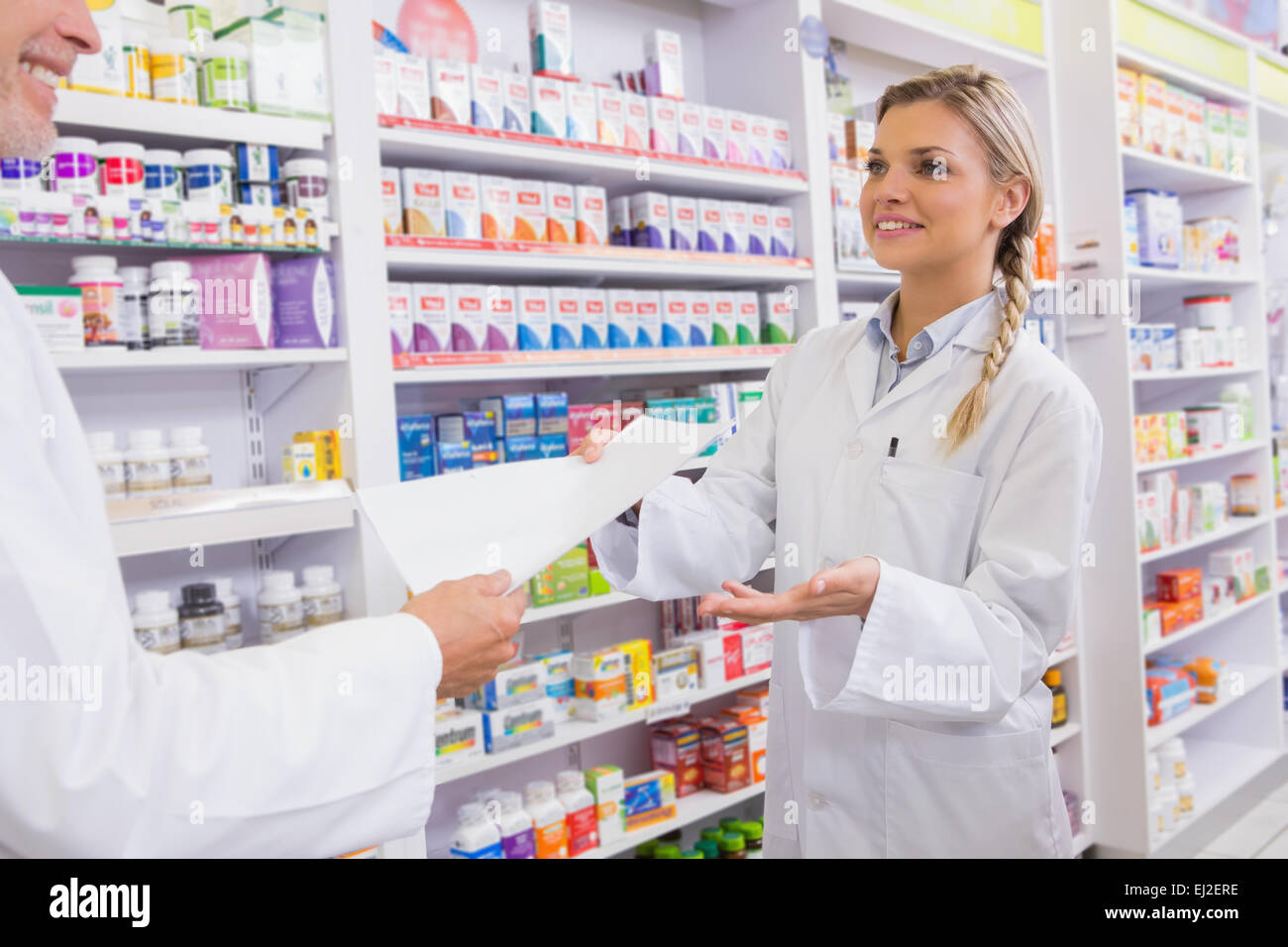 Pharmacist and trainee talking together about medication Stock Photo