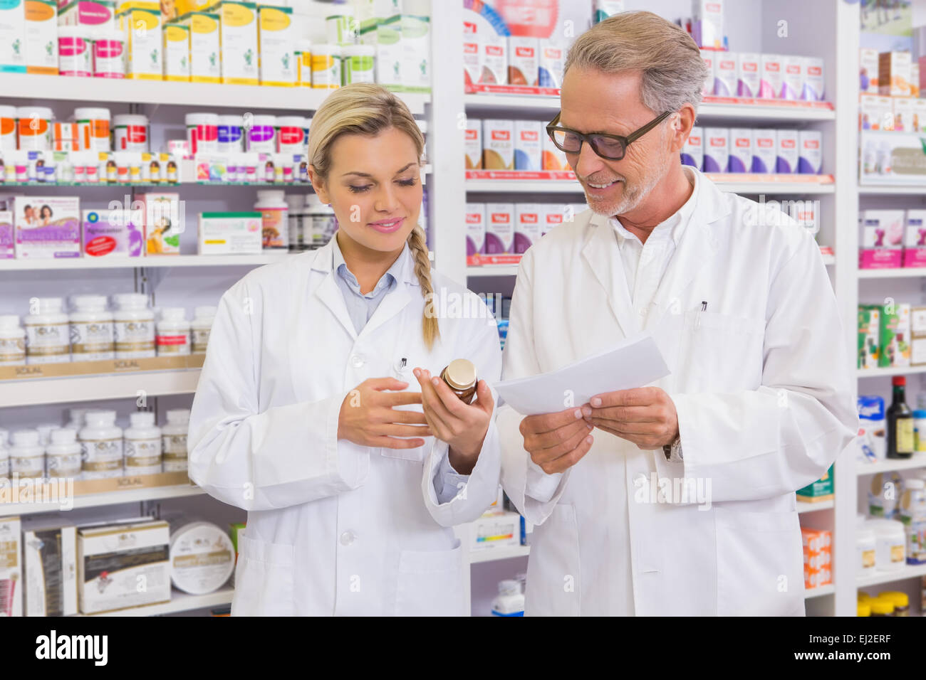 Pharmacist and trainee talking together about medication Stock Photo