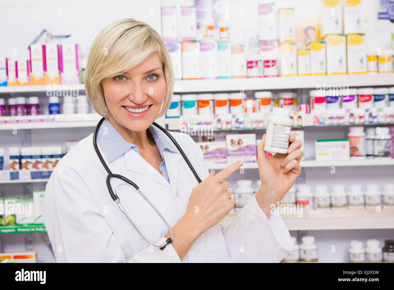 Smiling mature doctor pointing hi-res stock photography and images - Alamy