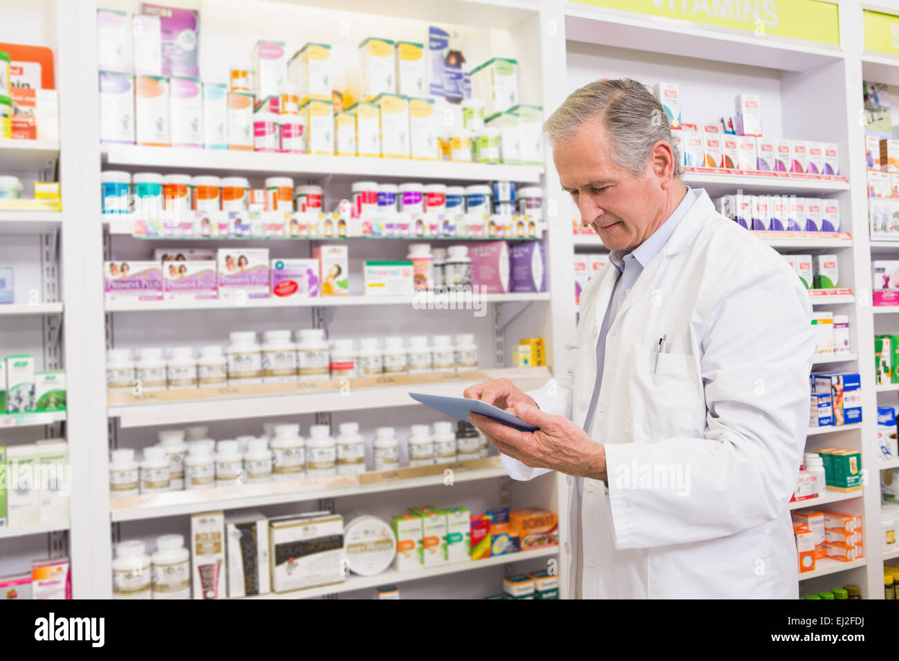 Pharmacist Using A Computer Senior pharmacist using tablet pc Stock Photo - Alamy
