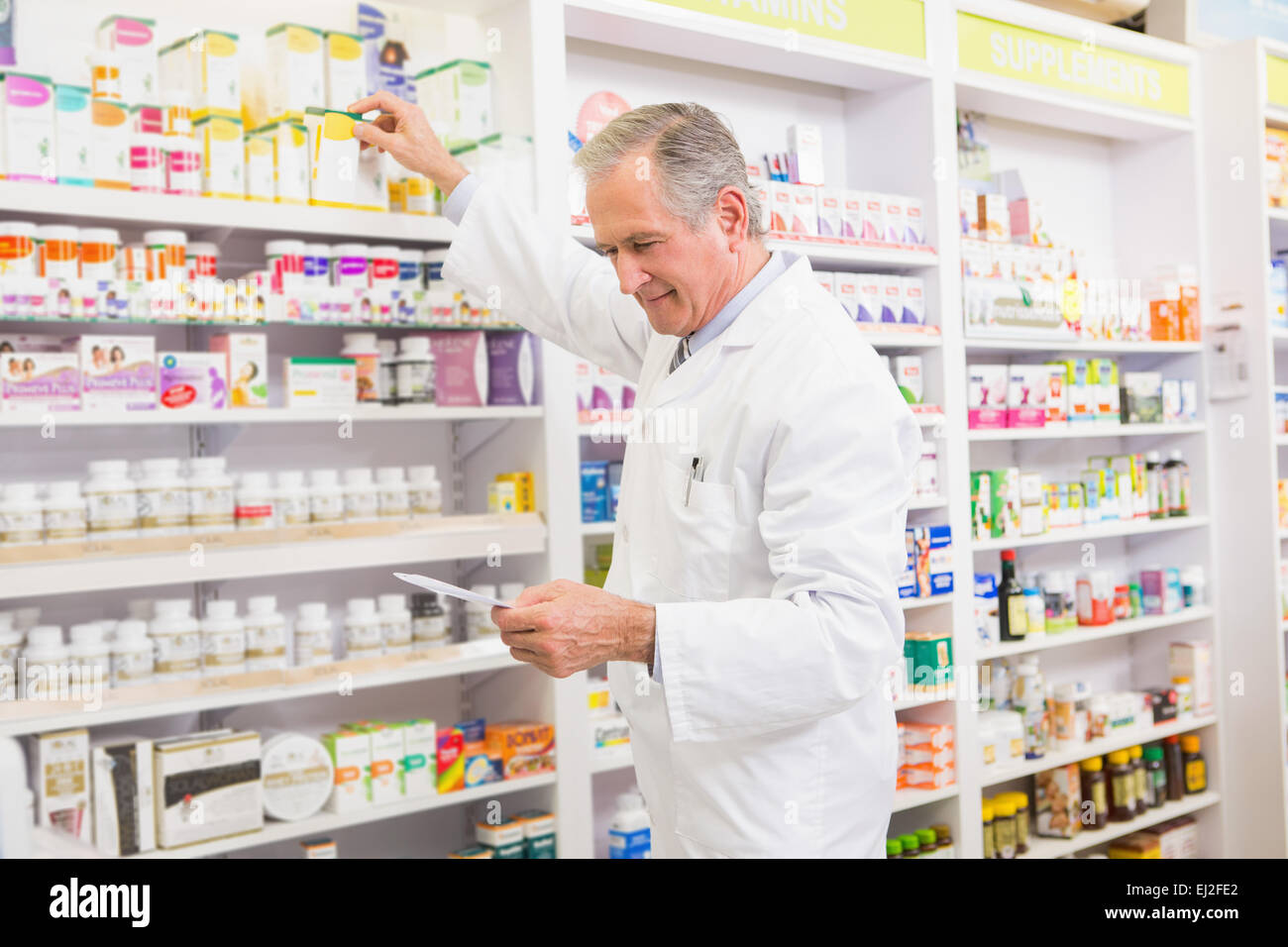 Pharmacist taking medicine from shelf Stock Photo Alamy