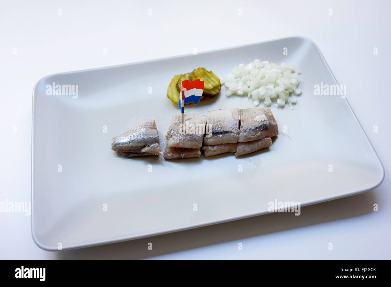 A soused herring, known as Maatjesharing served on a plate in Amsterdam
