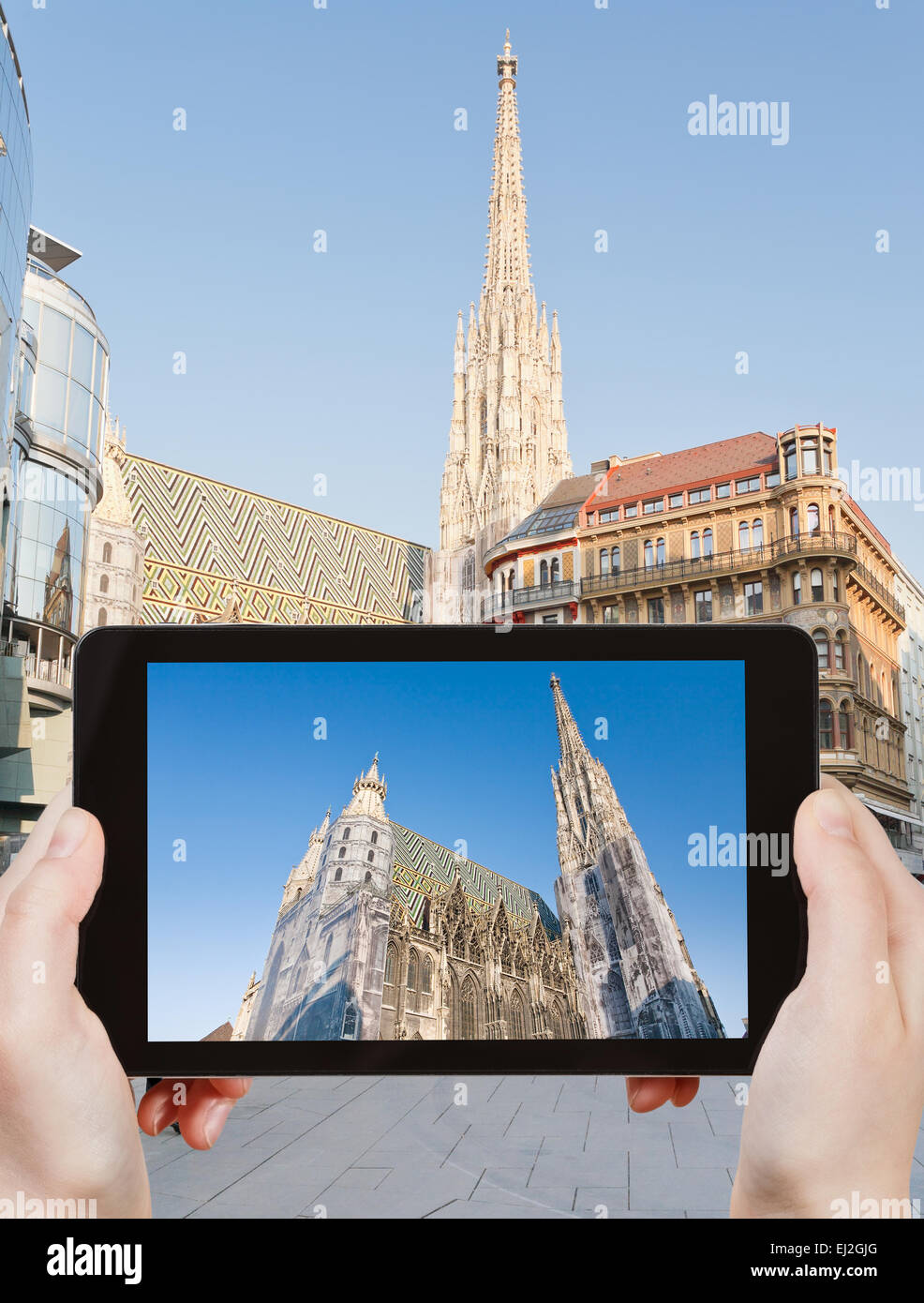 travel concept - tourist takes picture of St Stephan Cathedral, Vienna, Austria on smartphone, Stock Photo