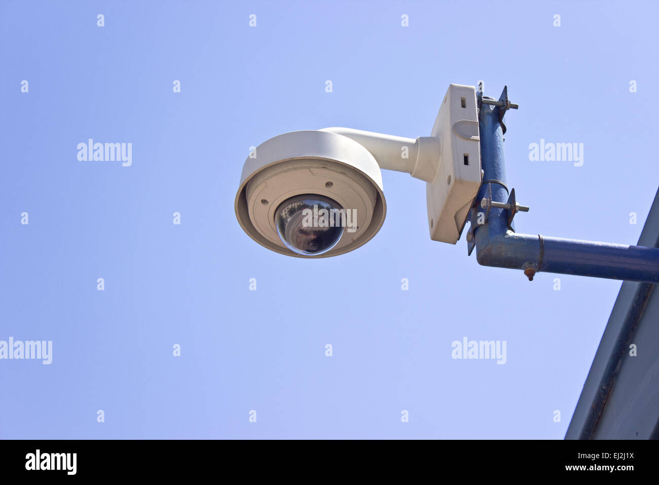 Hi-tech dome type surveillance camera over blue sky Stock Photo