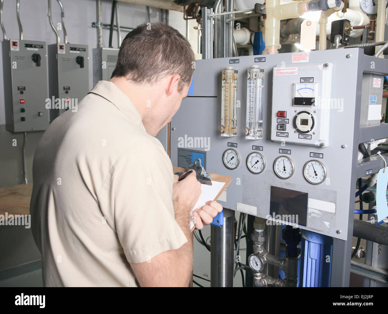 Air Conditioner Repair Man at work Stock Photo