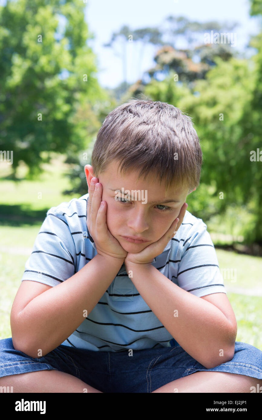 Little boy feeling sad in the park Stock Photo - Alamy