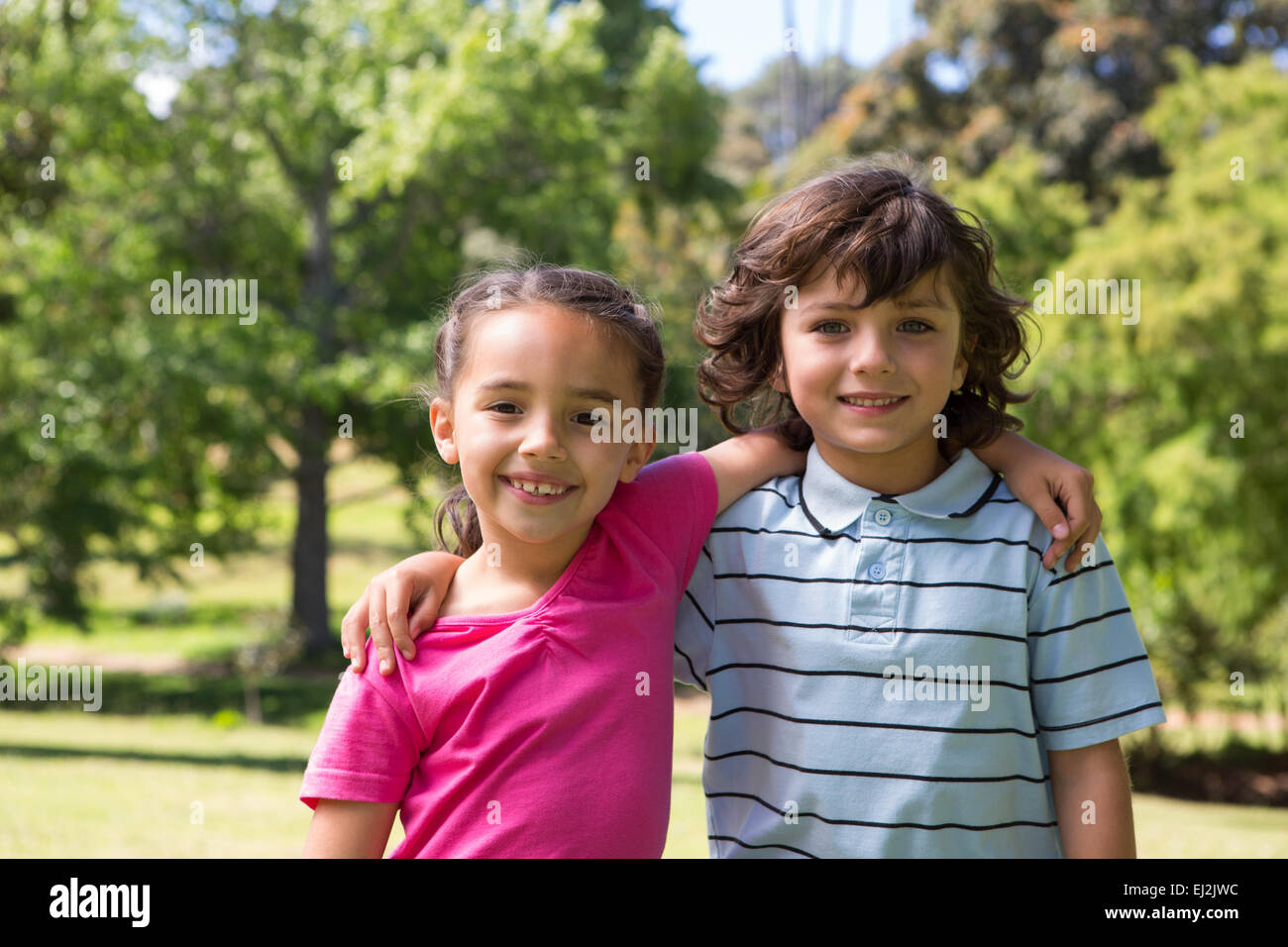 Little siblings smiling at camera Stock Photo - Alamy