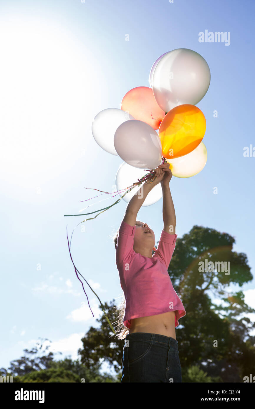 Happy little girl holding balloons Stock Photo Alamy