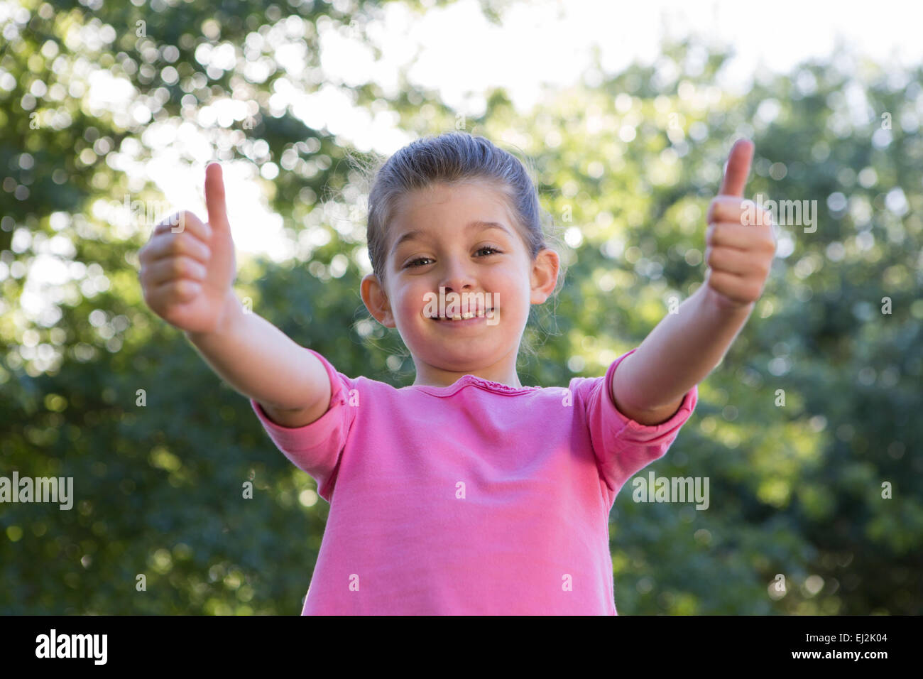 Happy little girl smiling at camera Stock Photo - Alamy