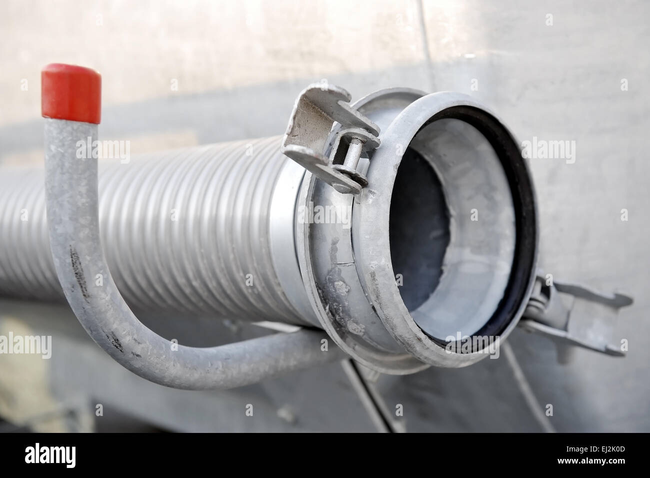 Industrial metal hose from a cistern reservoir Stock Photo