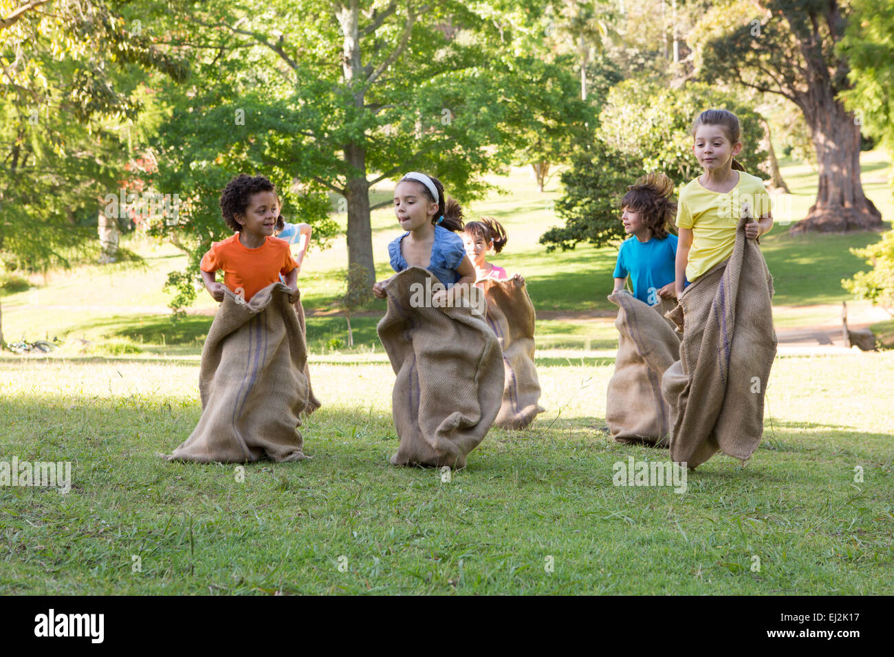 Children having a sack race in park Stock Photo Alamy