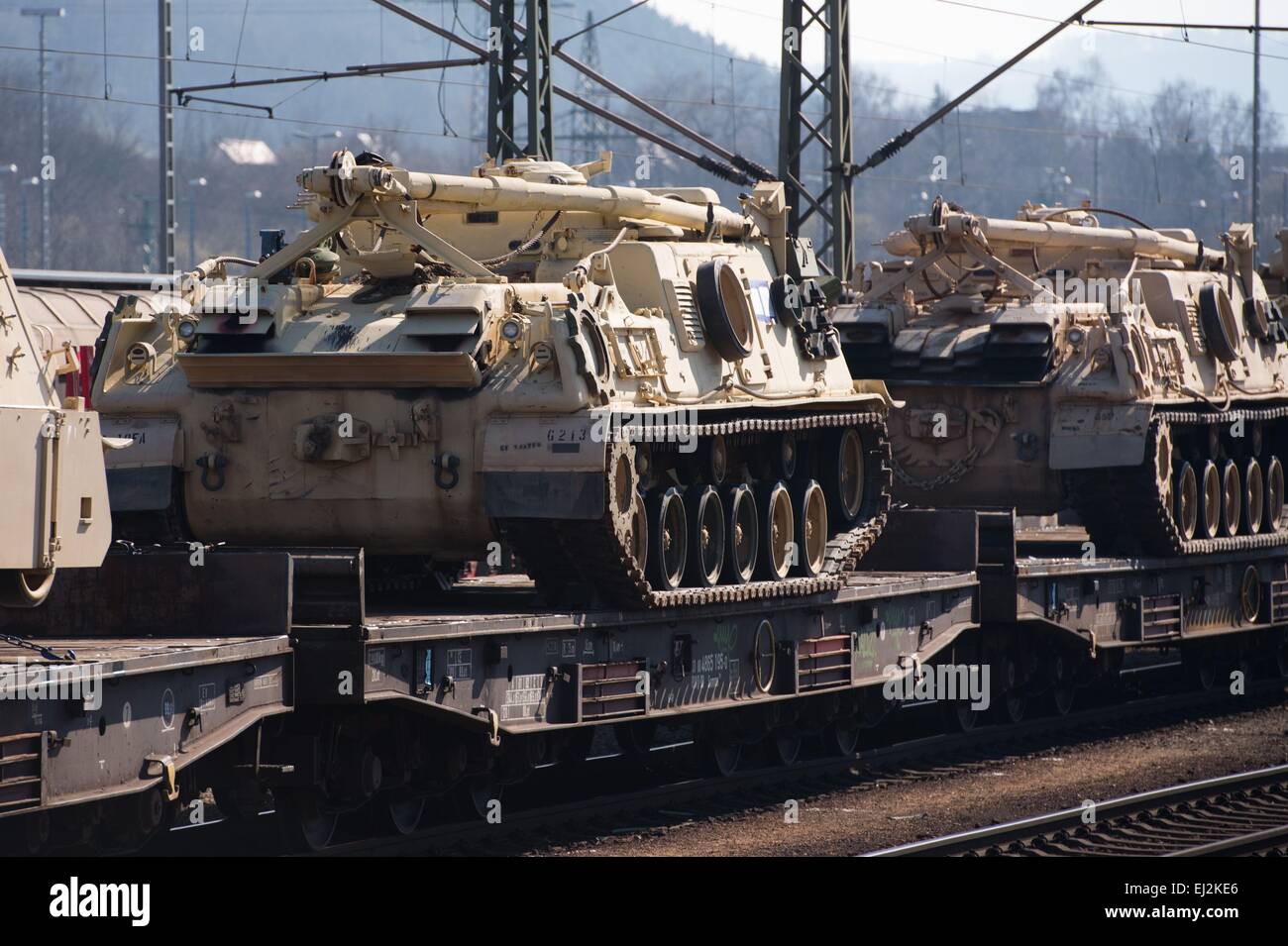 Tanks of the US Army stand loaded on a freight train on the train