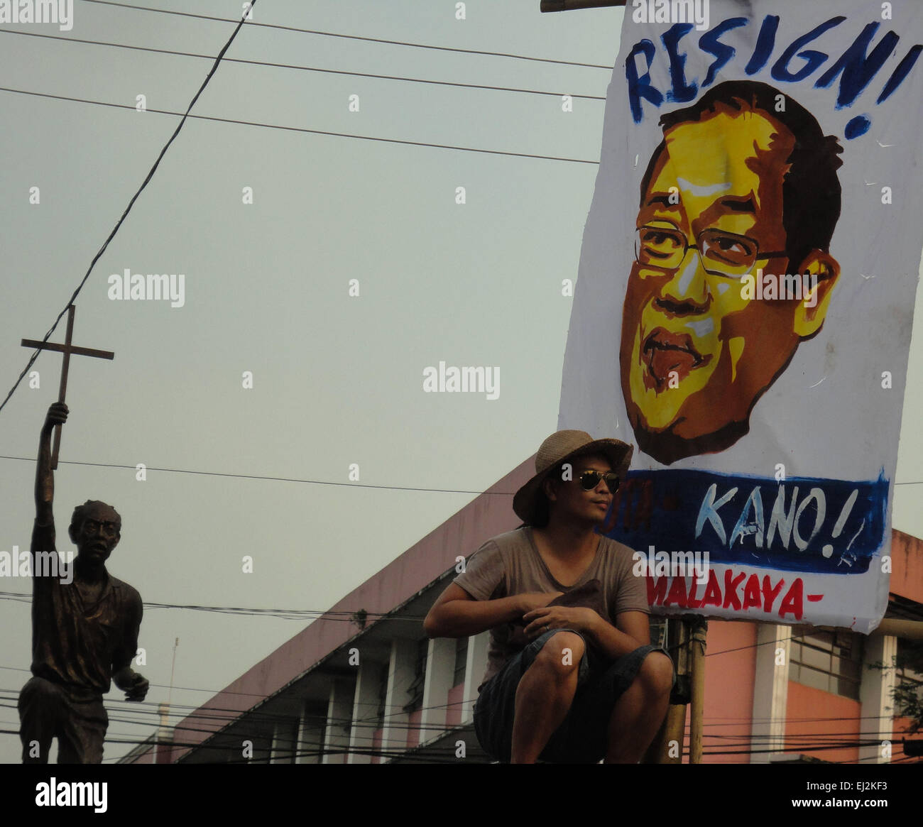 Manila, Philippines. 20th Mar, 2015. A Filipino activist takes a rest beside a banner calling for the resignation of Philippine President Benigno Aquino III, during a rally at Mendiola. President Aquino is facing calls for his removal over the botched anti-terror operation last January 25 in Mamasapano, Maguindanao to hunt wanted Malaysian bombmaker Zulkifri bin Hir, alias Marwan, that resulted in the deaths of 44 police commandos. Credit:  Richard James Mendoza/Pacific Press/Alamy Live News Stock Photo