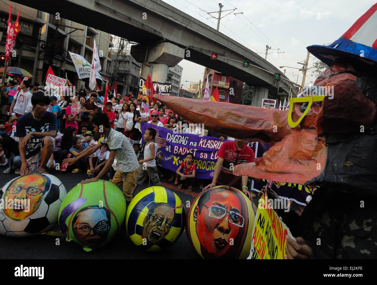 A Filipino activist wearing a mask depicting Philippine President Benigno Aquino III as 'Pinocchio' donning a US-styled top hat looks on as fellow activists arrange balls containing different facial gestures of the Philippine president, during a rally at Mendiola. President Aquino is facing calls for his removal over the botched anti-terror operation last January 25 in Mamasapano, Maguindanao to hunt wanted Malaysian bombmaker Zulkifri bin Hir, alias Marwan, that resulted in the deaths of 44 police commandos. (Photo by Richard James Mendoza/Pacific Press) Stock Photo