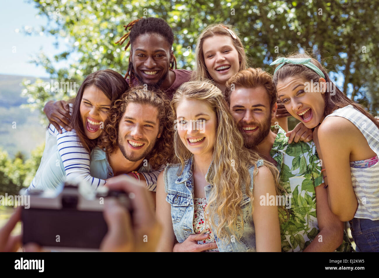 Happy young friends posing together Stock Photo - Alamy