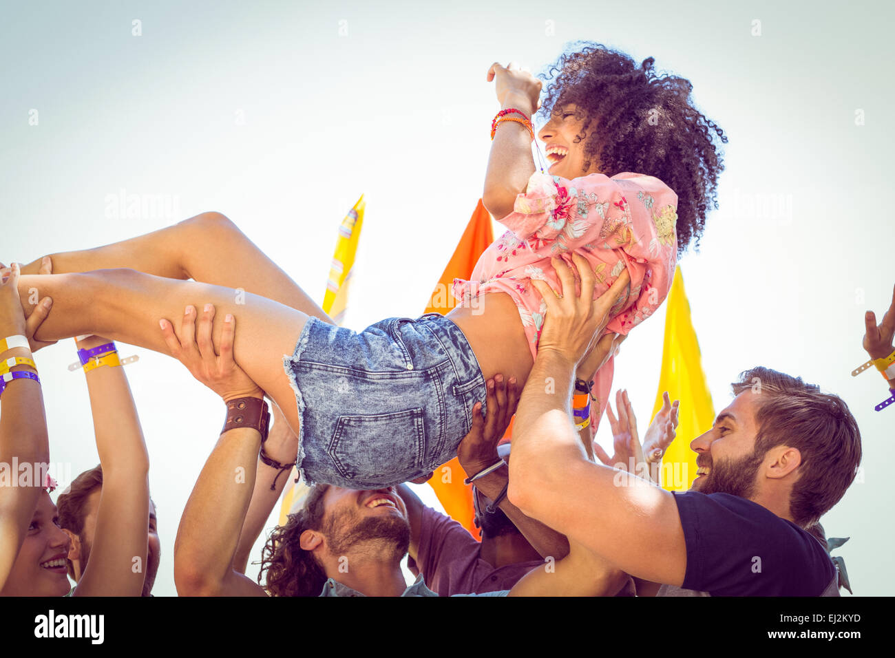 Happy hipster woman crowd surfing Stock Photo