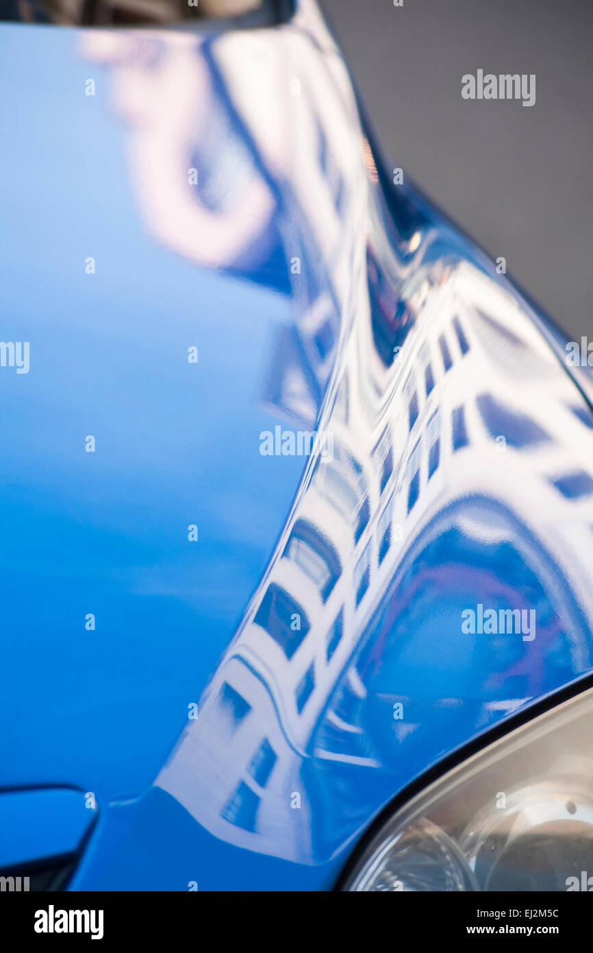 distorted building reflections in car bonnet at Old Town, Krakow, Poland in September Stock Photo