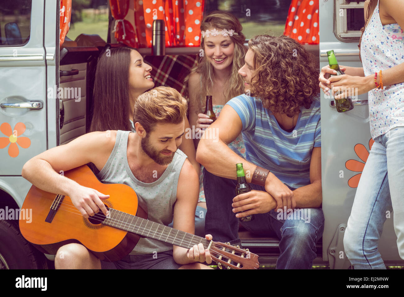 Hipster friends in camper van at festival Stock Photo