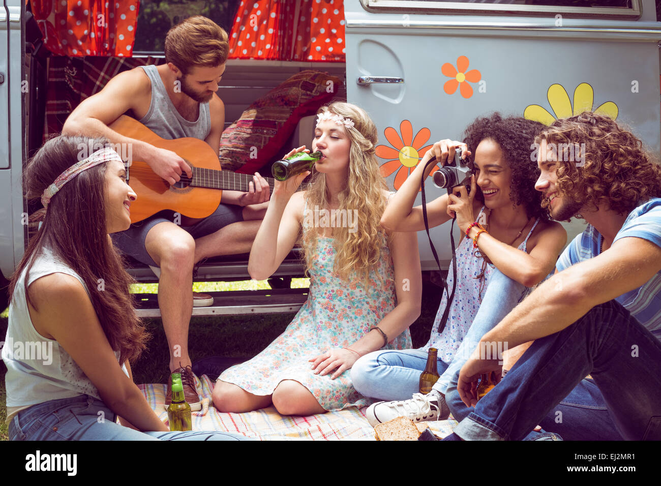 Hipster friends by camper van at festival Stock Photo