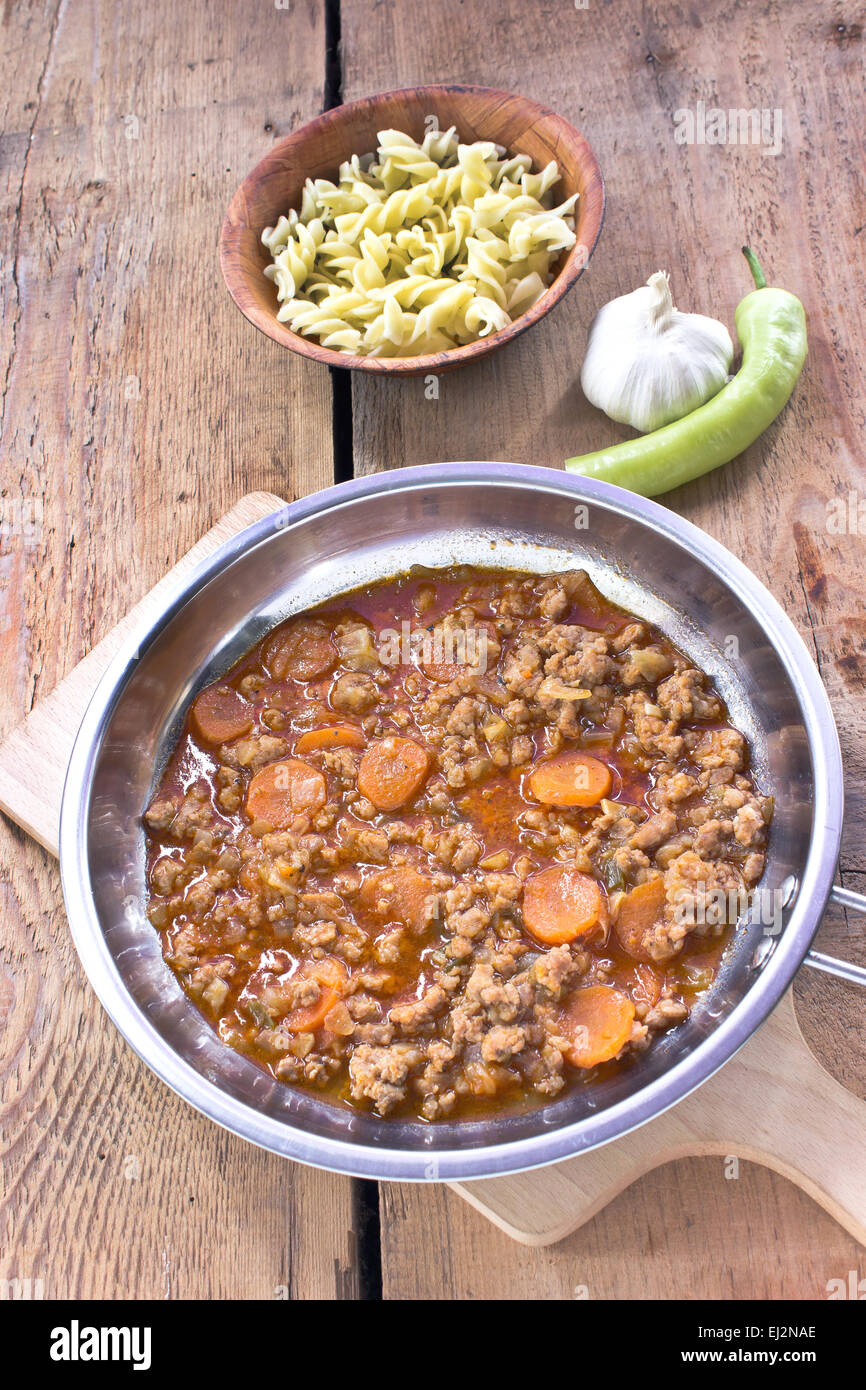 Minced meat sauce with vegetables cooked in pan with pasta Stock Photo