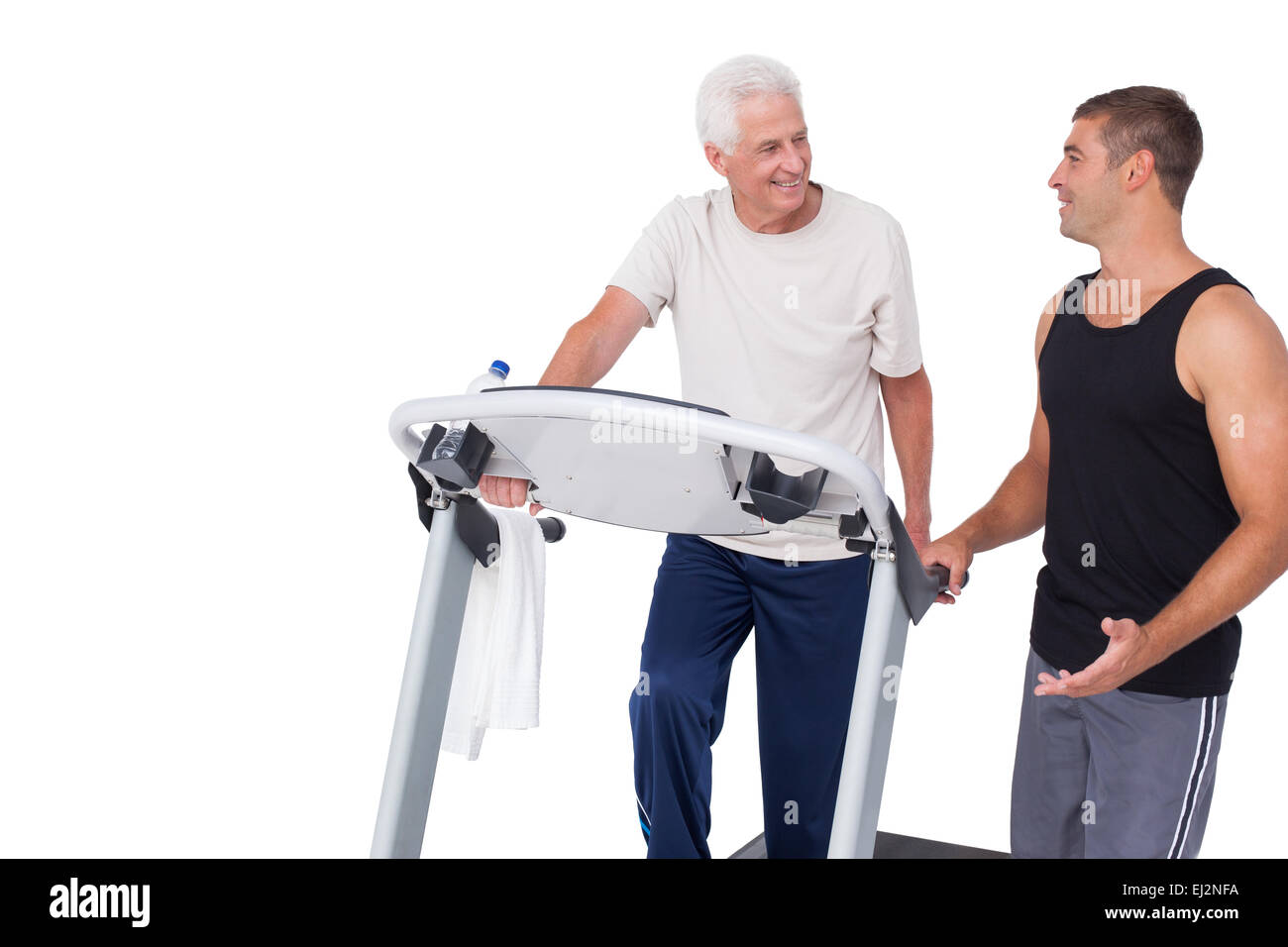Senior man on treadmill with trainer Stock Photo - Alamy