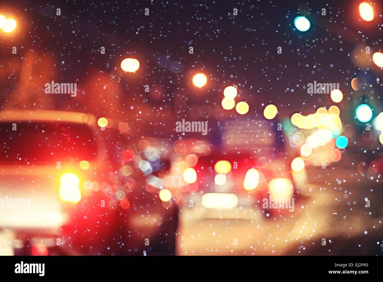 blurred night background city traffic road city lights winter snow glare Stock Photo