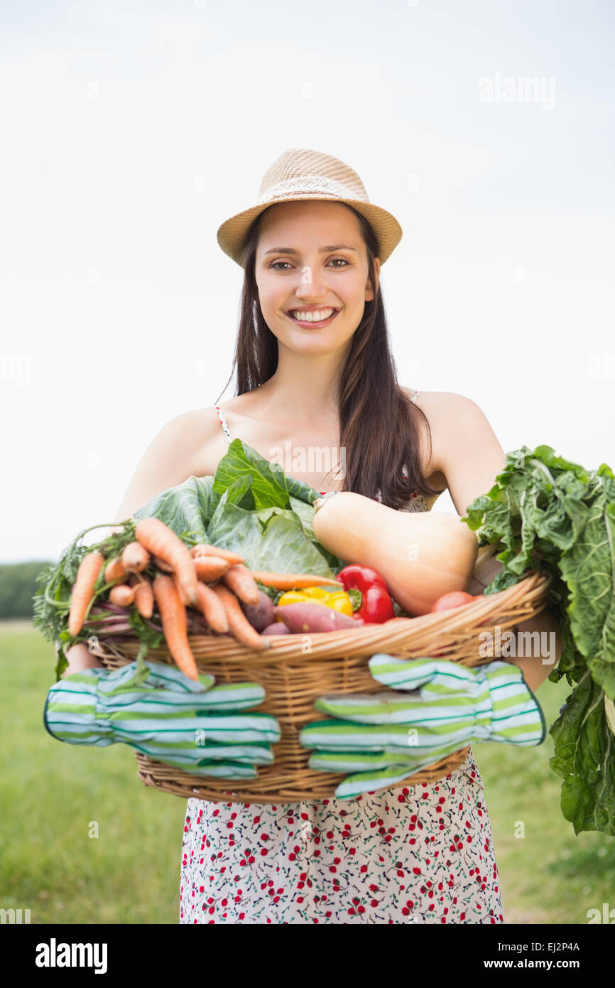 Pretty woman with basket of veg Stock Photo - Alamy